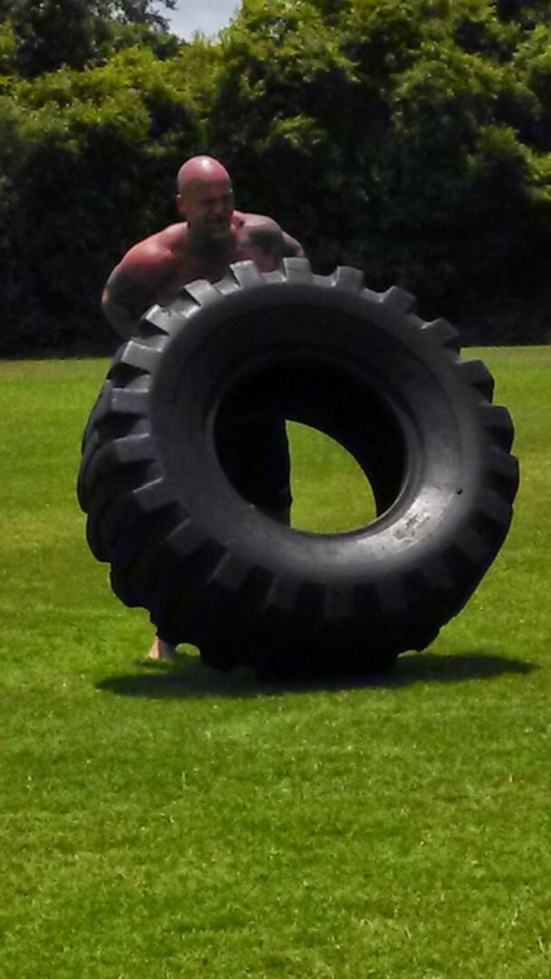 Man flipping a heavy tire
