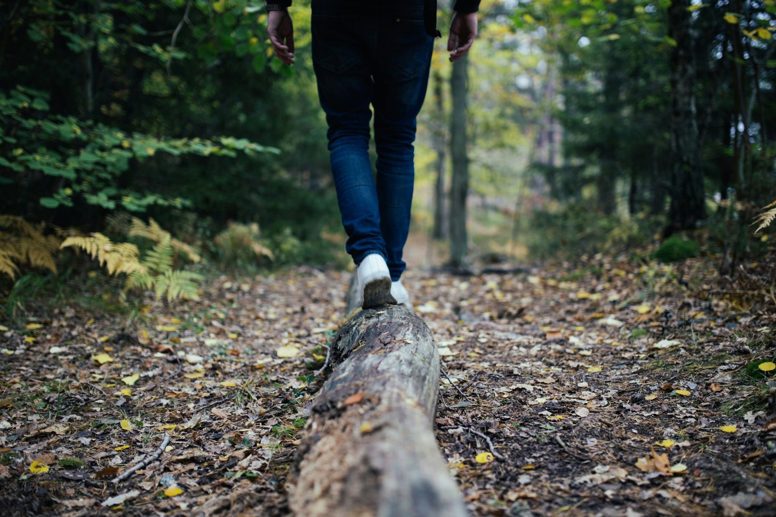 Man walking on a log to improve balance and stability