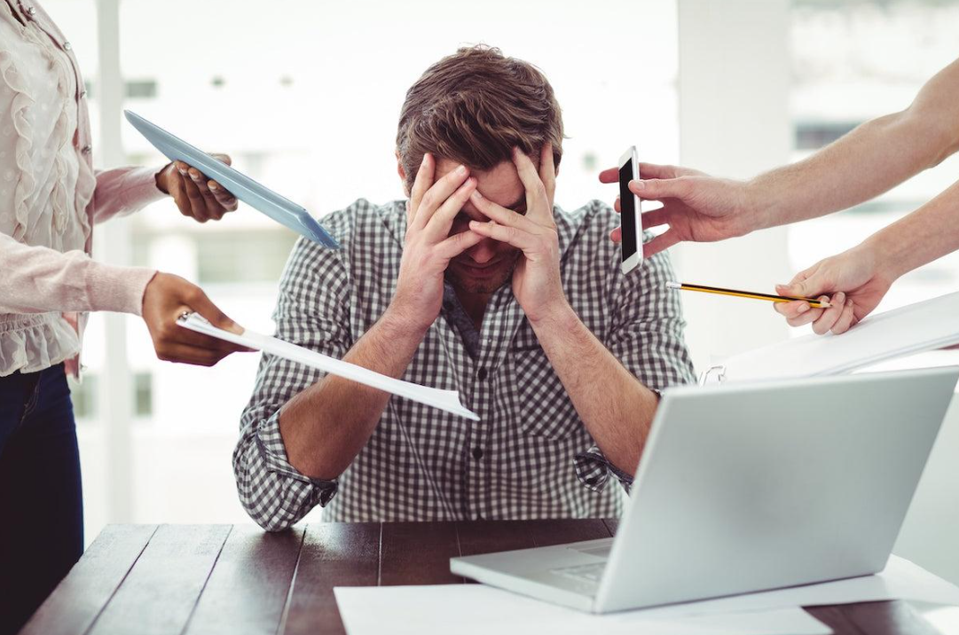 Person experiencing stress while working at a desk